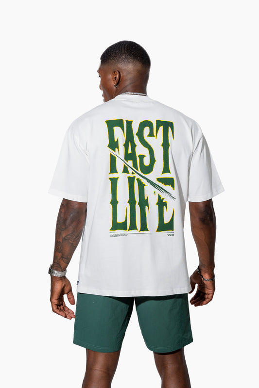 Man wearing an off-white t-shirt with FAST LIFE on it and green shorts on a white background