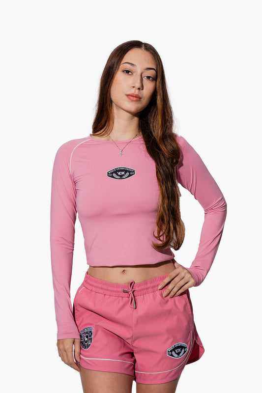 Woman wearing a pink athletic outfit with brand logos on a white background